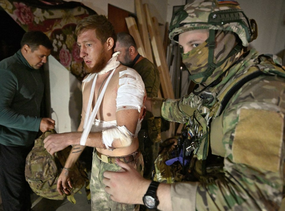 A wounded soldier being treated by medics.