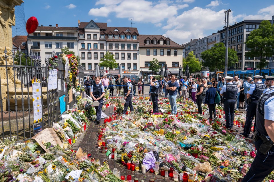 Memorial with flowers and candles for a police officer killed in Mannheim, Germany.