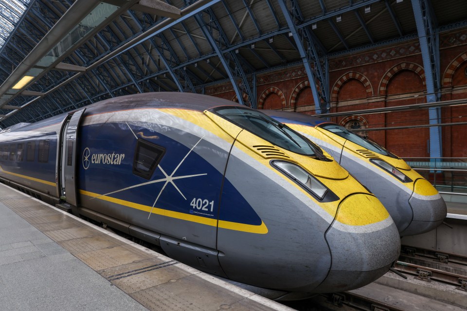 Two Eurostar trains at St. Pancras International station.
