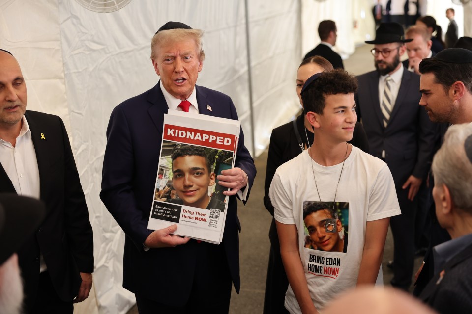 Donald Trump holding a sign with a photo of Edan Alexander, who was kidnapped by Hamas.