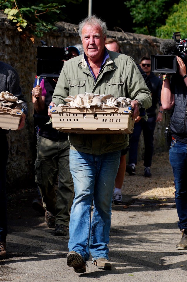 Jeremy Clarkson carrying a crate of mushrooms.