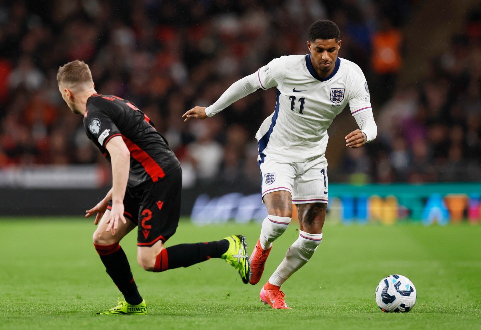 England's Marcus Rashford dribbling the ball past Albania's Ivan Balliu.