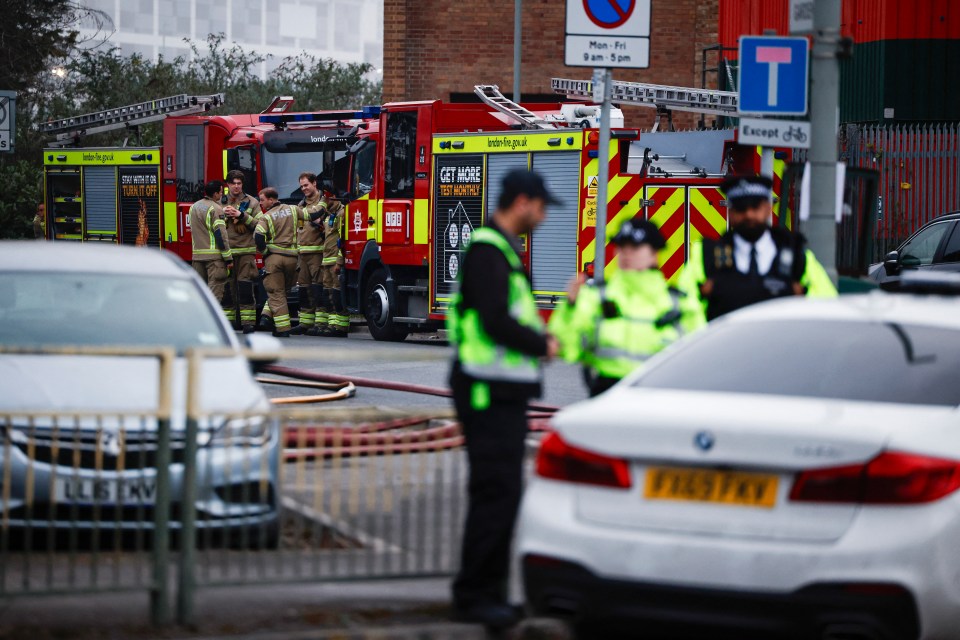 Firefighters and police officers at the scene of a fire at Heathrow Airport.