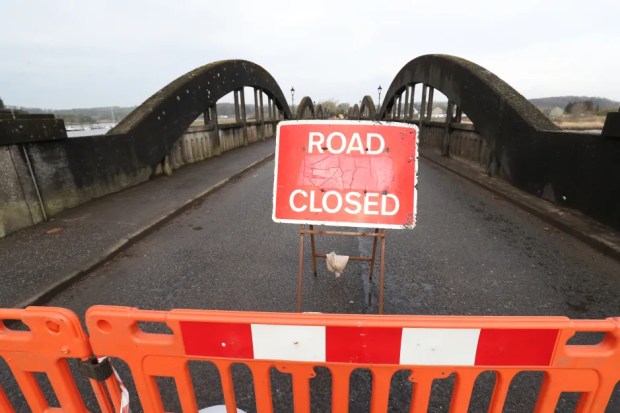 Road closed sign on a bridge.