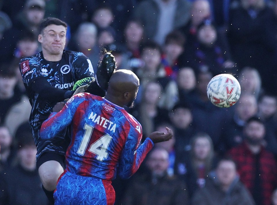 Millwall's Liam Roberts fouls Crystal Palace's Jean-Philippe Mateta during a soccer match.