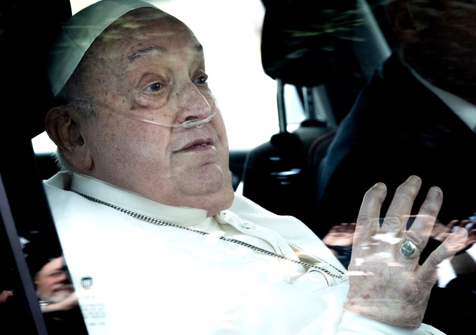 Pope Francis leaving the hospital in a car.
