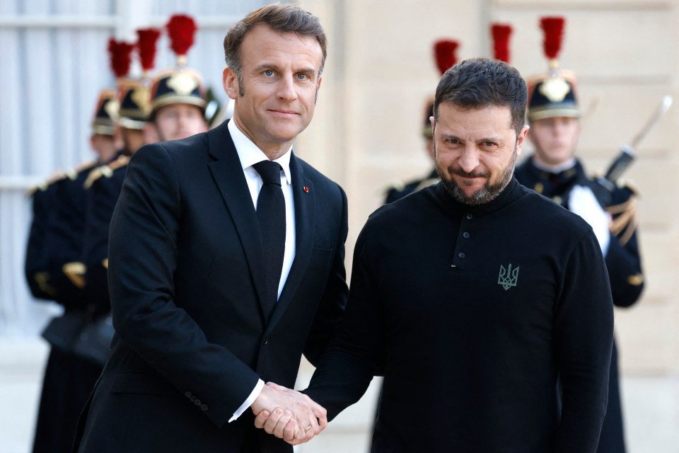Emmanuel Macron and Volodymyr Zelensky shaking hands.