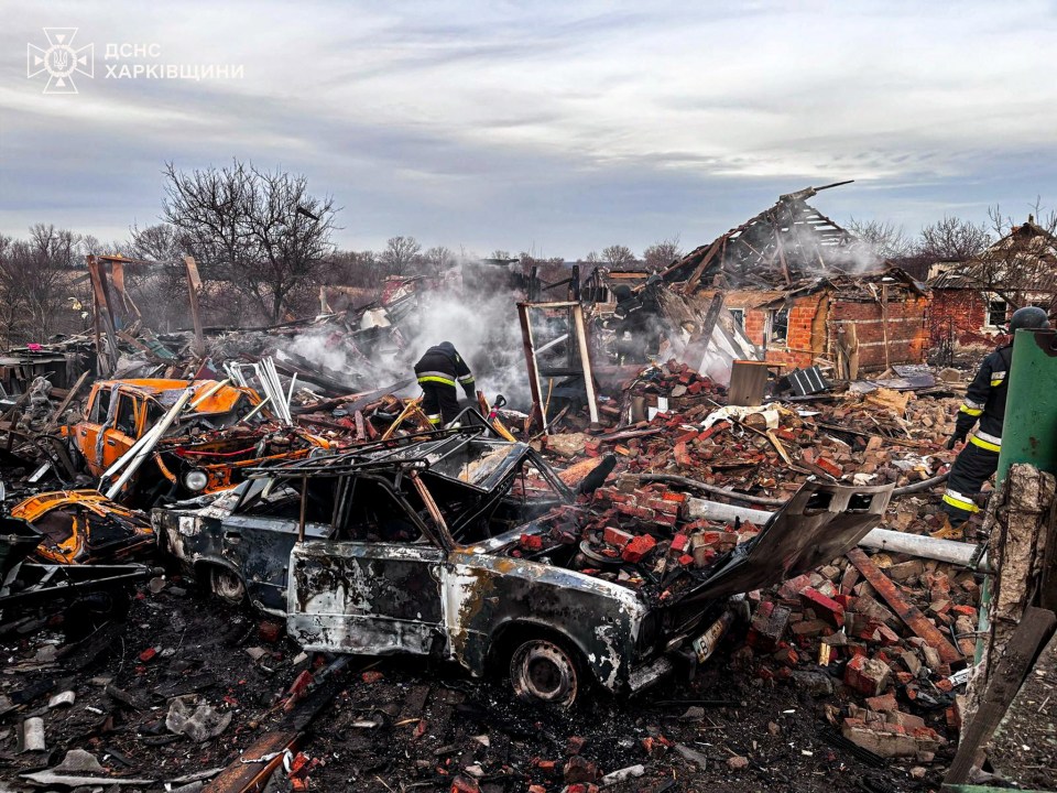 Firefighters at the site of houses destroyed by an air strike in Slatyne, Ukraine.