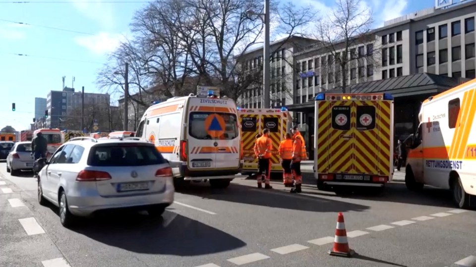 Ambulances and emergency personnel at the scene of a car accident.