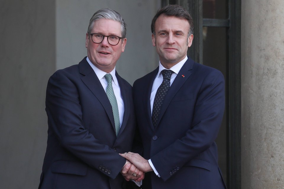 Emmanuel Macron and Keir Starmer shaking hands.