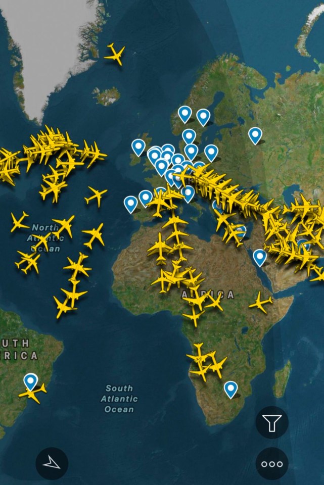 Flightradar24 app showing numerous airplanes in flight over a world map.