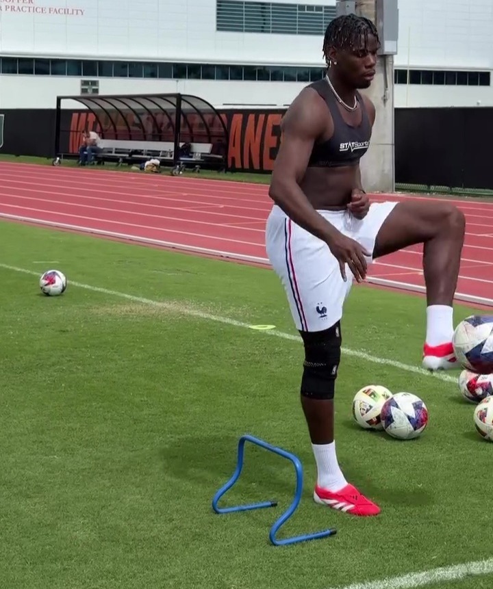 Paul Pogba training with soccer balls and hurdles.