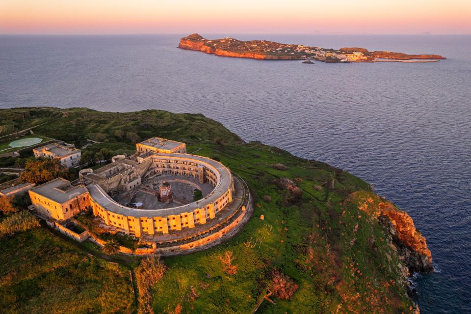 Aerial view of Santo Stefano prison on an island, with another island in the background.