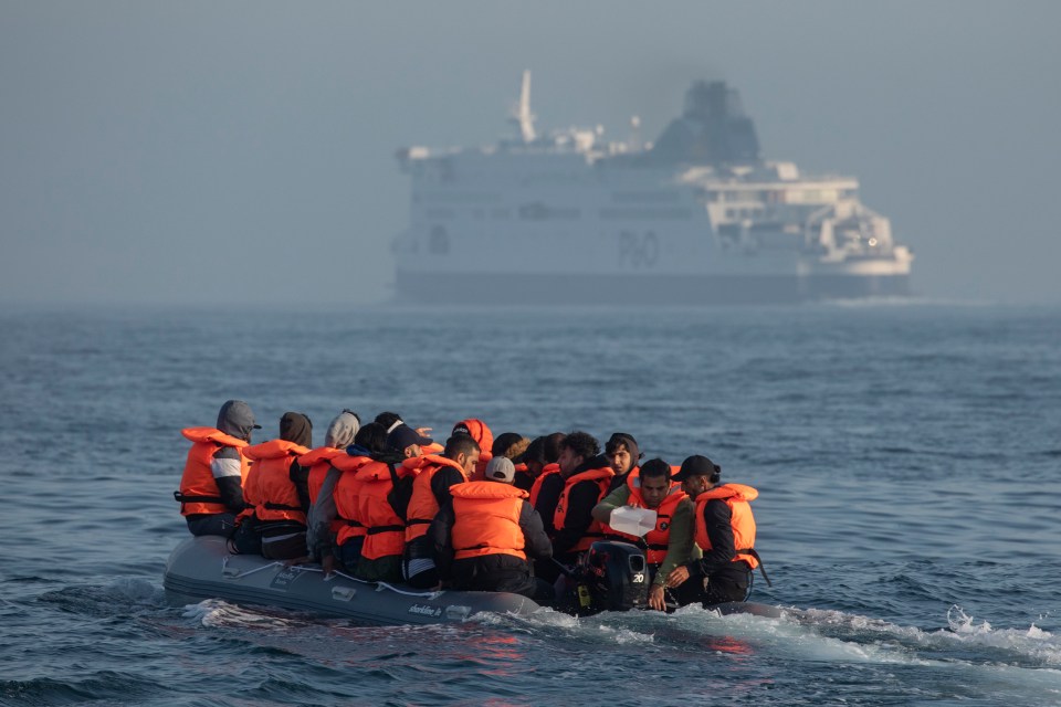 Migrants in an inflatable boat crossing the English Channel.