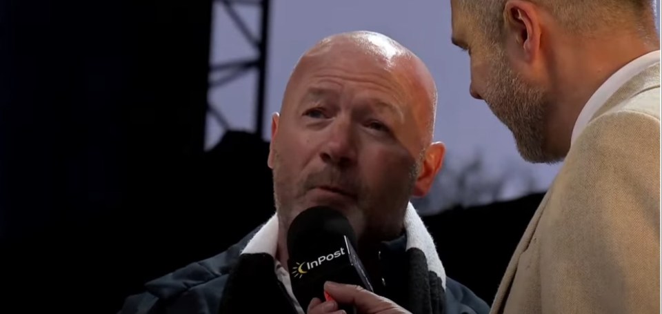 Man being interviewed with a microphone.