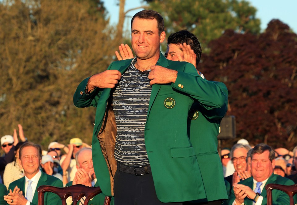Scottie Scheffler receiving the Green Jacket from Hideki Matsuyama.
