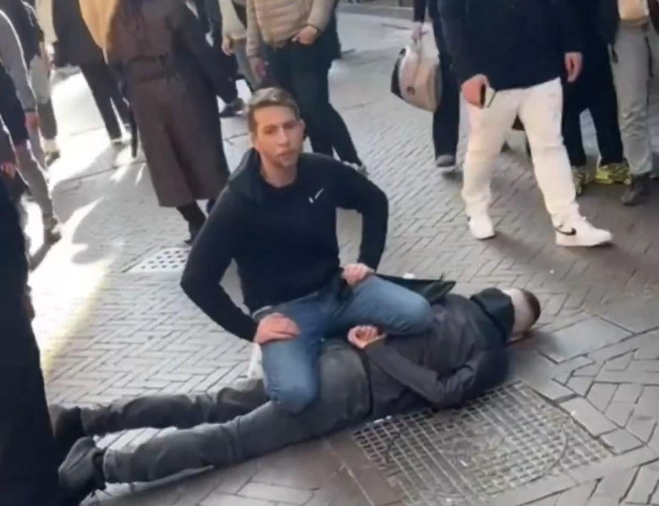 A man subduing a suspect on the ground in Amsterdam.