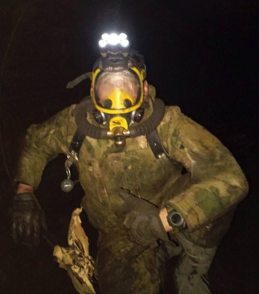 Russian soldier in a gas mask inside a damaged gas pipeline.
