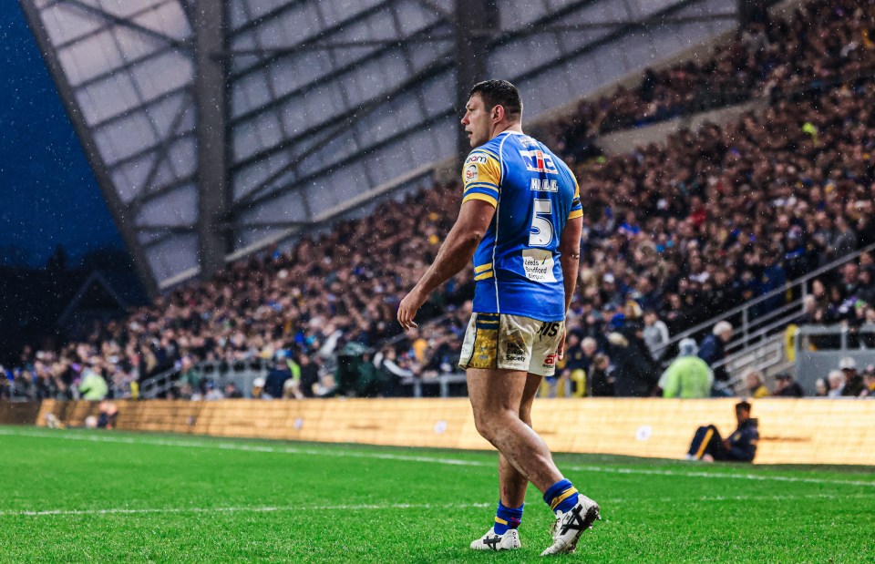 Rugby player walking on the field after a game.