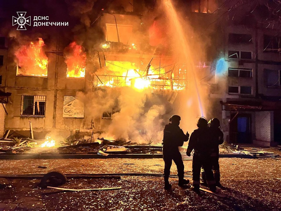 Firefighters battling a large fire at a building.