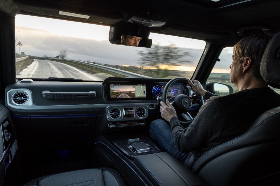 Man driving a Mercedes-Benz G-Class.