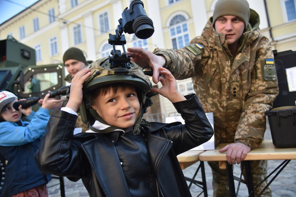 LVIV, UKRAINE - MARCH 22: People explore the equipment and tools of the State Border Guard Service of Ukraine during a public recruitment event at Rynok Square in Lviv, Ukraine on March 22, 2025. The event aimed to showcase the role of border guards in protecting Ukraine's borders and their involvement in the ongoing Russian-Ukrainian war, while encouraging citizens to join the service. (Photo by Michael Sorrow/Anadolu via Getty Images)