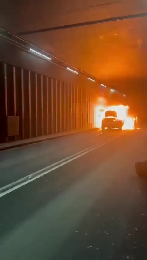 Car on fire in a tunnel.