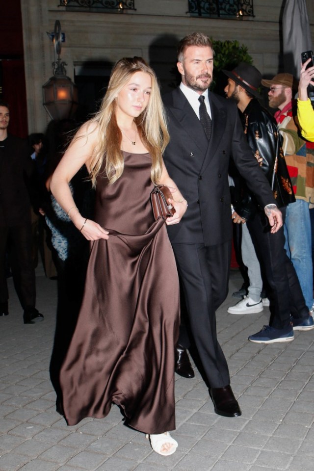 Harper Beckham and David Beckham leaving a hotel during Paris Fashion Week.