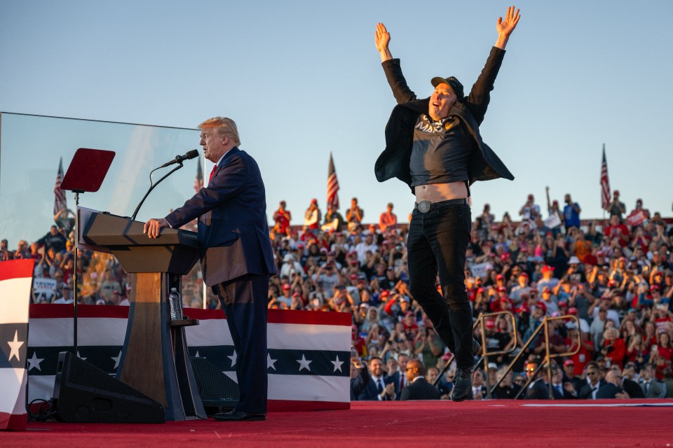 (FILES) Tesla CEO Elon Musk (R) jumps on stage as he joins former US President and Republican presidential candidate Donald Trump during a campaign rally at site of his first assassination attempt in Butler, Pennsylvania on October 5, 2024. Donald Trump will be the one taking the presidential oath next week, but in some respects, billionaire Elon Musk might as well place his hand on the Bible too. In an unprecedented relationship for modern US history, Trump will be heading into the White House shadowed by an advisor who is not only the world's richest person but matches the incoming president in terms of wild ambition, hard-right politics, and media influence. (Photo by Jim WATSON / AFP) (Photo by JIM WATSON/AFP via Getty Images)