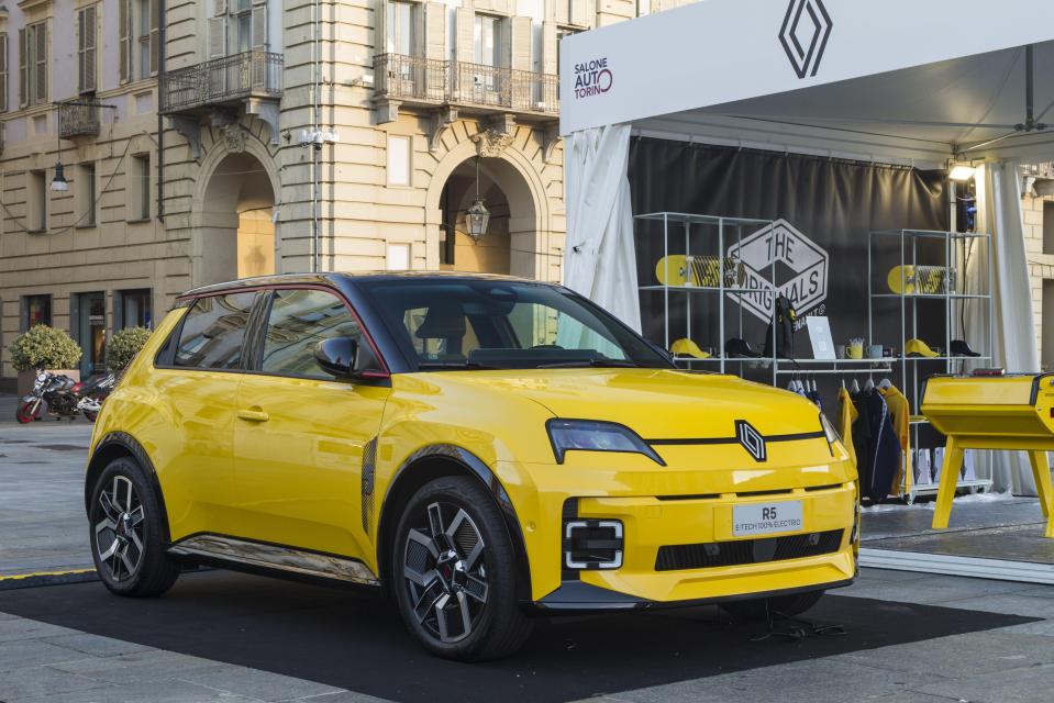 Yellow Renault 5 E-Tech Electric car at a car show.