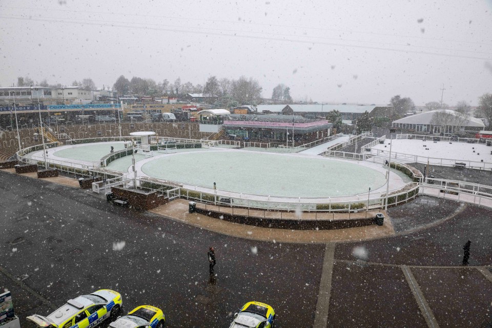 Snow falling on a race track.
