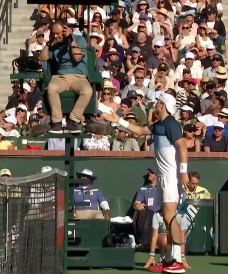 Tennis player arguing with umpire.