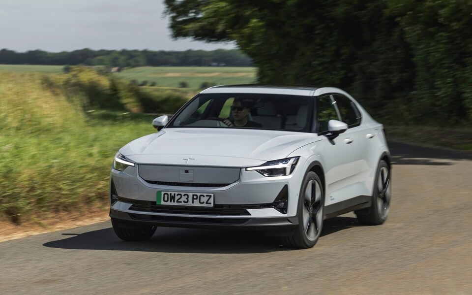 White Polestar driving on a road.