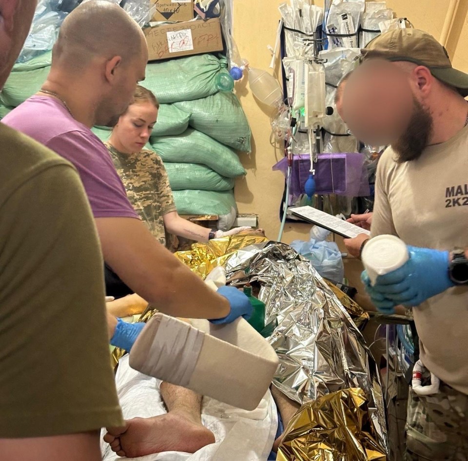 Medics treating a wounded soldier.