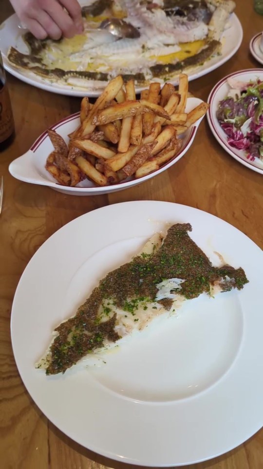 Herb-crusted fish with fries and salad.