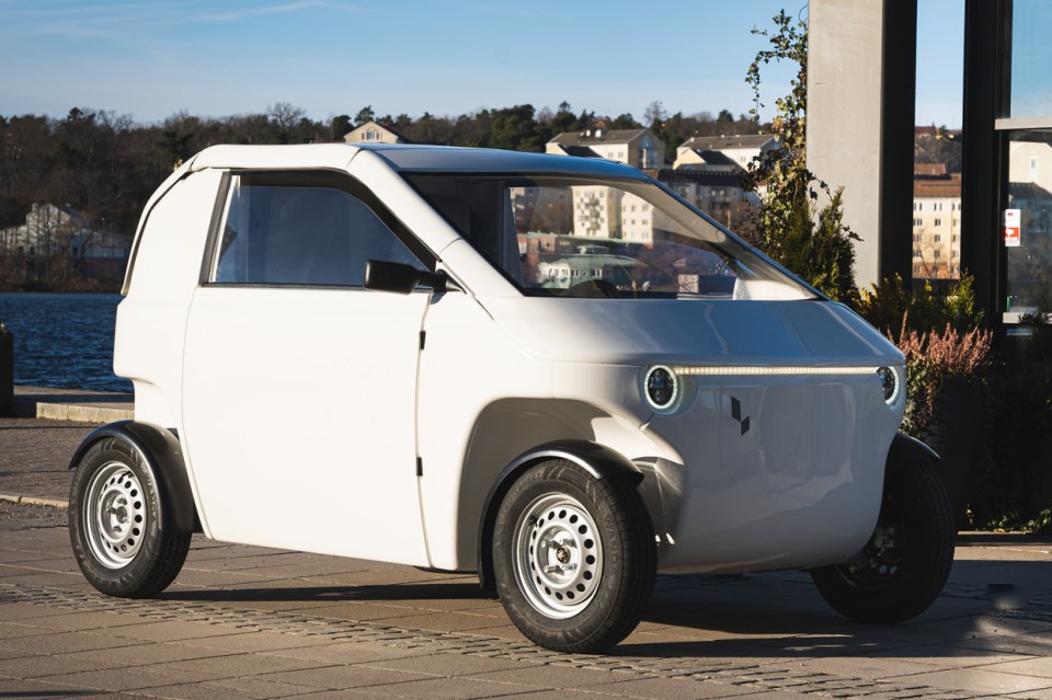 White electric car parked outdoors.