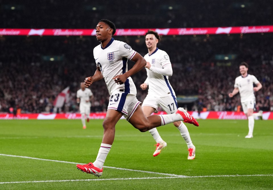 Soccer player celebrating a goal at Wembley Stadium.
