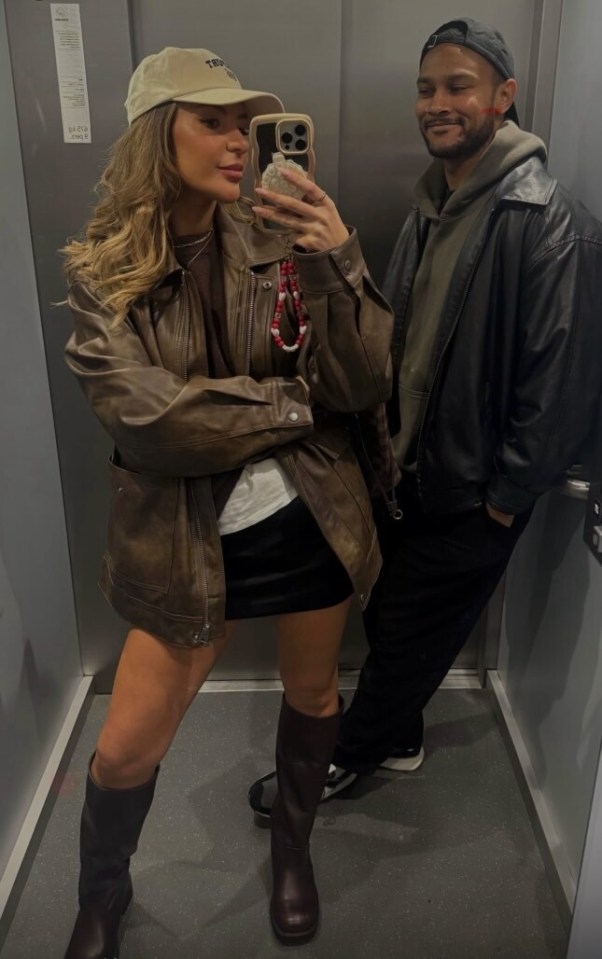 Couple taking a selfie in an elevator.