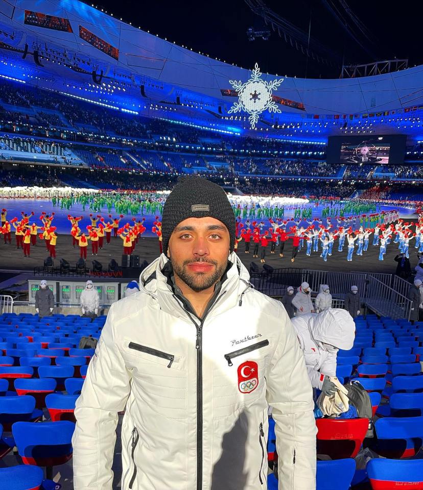 Man in white jacket at the Beijing Olympics.