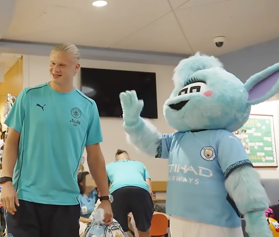 Manchester City players visiting a children's hospital.