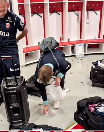 Person cleaning up debris in a locker room.