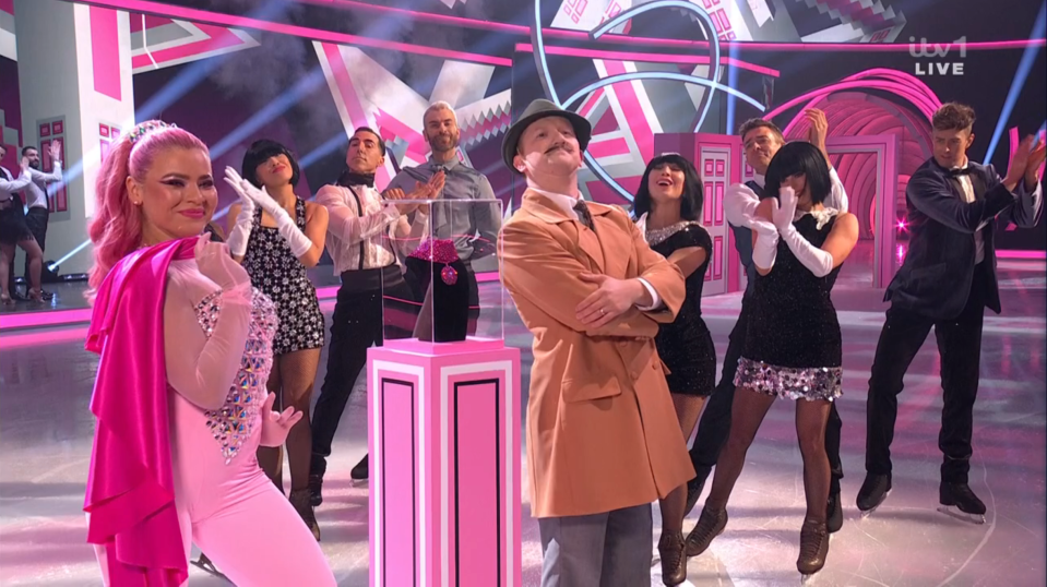 Screenshot of a skating show with performers in various costumes.