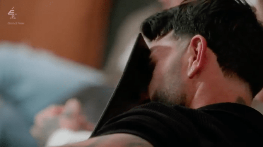 Man hiding his face with a tablet.