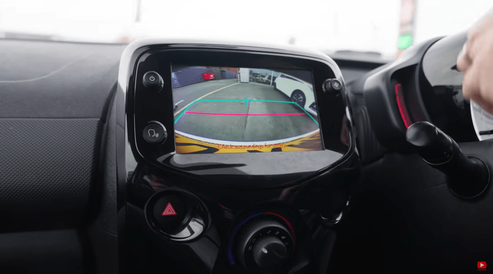 Car's rearview camera display showing parking guidelines.
