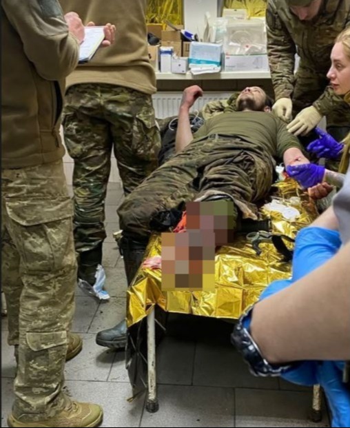 A wounded soldier receiving medical attention.