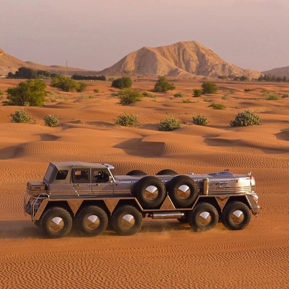 Large custom-built truck in a desert.