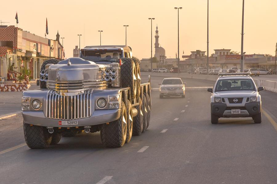 Large custom-built truck on a road.