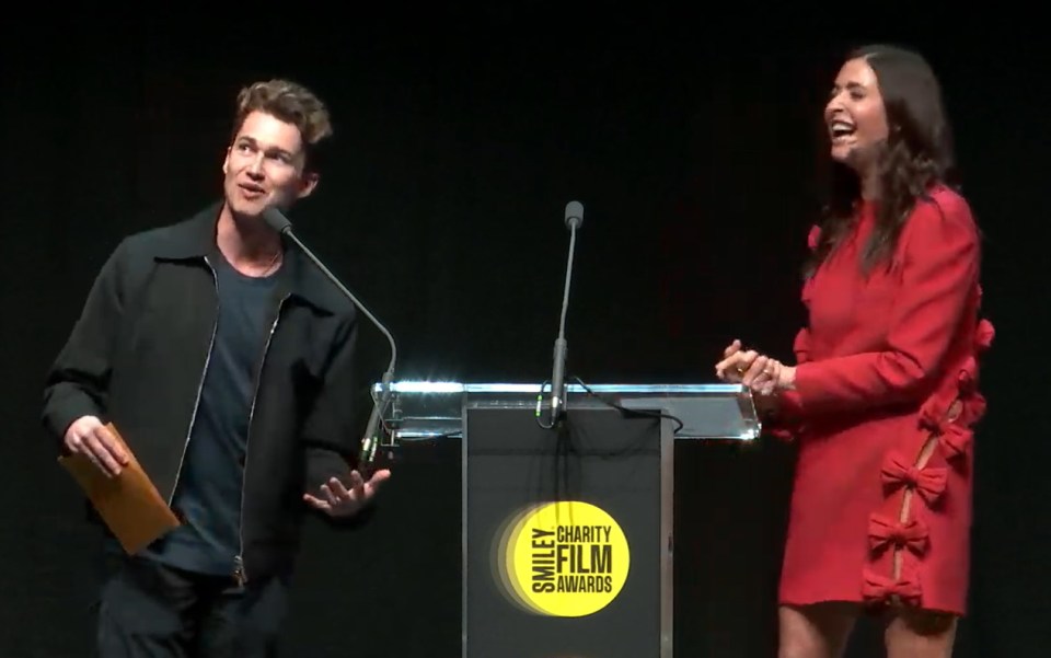 Two people presenting at the Smiley Charity Film Awards.