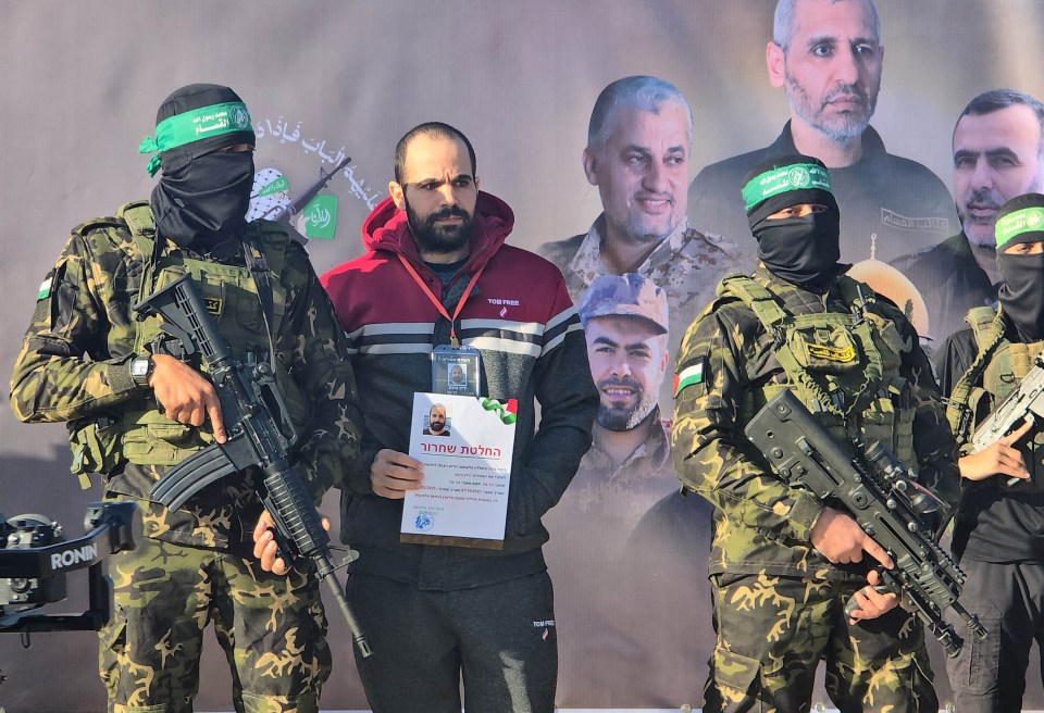 Al-Qassam Brigades members hand over an Israeli hostage in Gaza.
