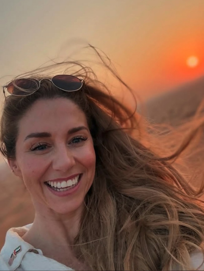 Alex Murphy Klein, former Dancing on Ice pro skater, smiling at sunset.